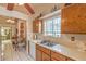 Bright kitchen with white countertops, wood cabinets, stainless steel sink and tile floors at 2735 Poppyseed Way, Las Vegas, NV 89142