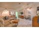 Comfortable living room with a large sectional sofa, tile floors, a ceiling fan, and plenty of natural light at 2735 Poppyseed Way, Las Vegas, NV 89142