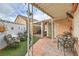 Charming covered patio featuring brick flooring, seating, and decorative elements, perfect for outdoor relaxation and entertainment at 2735 Poppyseed Way, Las Vegas, NV 89142