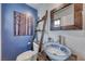 Stylish powder room with blue accent wall, vessel sink, and rustic decor at 2809 Gilmary Ave, Las Vegas, NV 89102