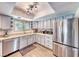 Well-lit kitchen with stainless steel appliances, light blue cabinetry, and ample counter space at 2809 Gilmary Ave, Las Vegas, NV 89102
