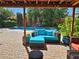 Inviting covered brick patio seating area with a plush blue cushioned sofa overlooking the sparkling pool at 2809 Gilmary Ave, Las Vegas, NV 89102