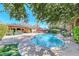 Beautiful pool surrounded by lush greenery, patio, and comfortable outdoor seating at 2809 Gilmary Ave, Las Vegas, NV 89102
