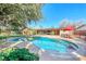 Beautiful pool surrounded by lush greenery, patio, and comfortable outdoor seating at 2809 Gilmary Ave, Las Vegas, NV 89102