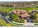 Aerial shot of the home highlighting the pool, lush landscaping, red tile roof and its location next to a golf course at 2994 San Lorenzo Ct, Henderson, NV 89052