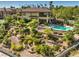 A luxurious backyard with a sparkling pool, lush landscaping, and terraced garden, creating a private oasis at 2994 San Lorenzo Ct, Henderson, NV 89052