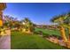 Lush backyard with artificial turf, manicured landscaping, and views of the golf course at 2994 San Lorenzo Ct, Henderson, NV 89052