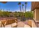 A cozy balcony featuring seating and offering views of palm trees and the surrounding landscape at 2994 San Lorenzo Ct, Henderson, NV 89052