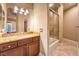 Elegant bathroom featuring a granite vanity, a large mirror, and a shower at 2994 San Lorenzo Ct, Henderson, NV 89052
