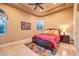 Cozy bedroom features a tray ceiling, natural light from an arched window, and tile floors, a relaxing retreat at 2994 San Lorenzo Ct, Henderson, NV 89052