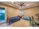 Cozy bedroom featuring two twin beds, a ceiling fan, and a sliding glass door leading to a balcony with scenic views at 2994 San Lorenzo Ct, Henderson, NV 89052