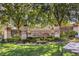 Stone community entrance with manicured lawn and mature trees provides a welcoming atmosphere at 2994 San Lorenzo Ct, Henderson, NV 89052