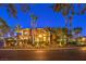 Elegant two-story home featuring manicured landscaping, a private balcony, and a well-lit exterior at 2994 San Lorenzo Ct, Henderson, NV 89052