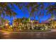 Elegant home with manicured landscaping and mature trees, lit beautifully at night at 2994 San Lorenzo Ct, Henderson, NV 89052