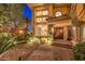 Elegant front entrance with double doors, a brick walkway, mature landscaping, and a view of the grand windows at 2994 San Lorenzo Ct, Henderson, NV 89052