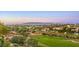 Scenic view of a lush golf course with city and mountain views, offering a serene and picturesque setting at 2994 San Lorenzo Ct, Henderson, NV 89052