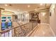 Well-lit hallway featuring elegant railings, chandelier views, and an open floor plan at 2994 San Lorenzo Ct, Henderson, NV 89052