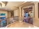 Open hallway with detailed railings leading to a living area with a fireplace at 2994 San Lorenzo Ct, Henderson, NV 89052