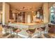 An open kitchen design features barstool seating at the breakfast bar, stone countertops, and stainless steel appliances at 2994 San Lorenzo Ct, Henderson, NV 89052
