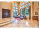 Bright living room featuring high ceilings, large windows, and a comfortable blue sectional sofa at 2994 San Lorenzo Ct, Henderson, NV 89052