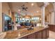 Open living space with ceiling fans, pillars, granite countertops, and elegant furnishings at 2994 San Lorenzo Ct, Henderson, NV 89052