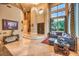 Spacious living room featuring a blue sectional sofa, high ceilings, and elegant marble flooring at 2994 San Lorenzo Ct, Henderson, NV 89052