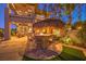 A tiki-style outdoor bar and grill area with seating and a fire feature, perfect for entertaining at 2994 San Lorenzo Ct, Henderson, NV 89052