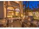 Outdoor kitchen with stainless steel grill and sink overlooking interior rooms through large arched windows at 2994 San Lorenzo Ct, Henderson, NV 89052