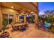 Spacious covered patio features stylish dining and bar areas alongside a beautiful outdoor pool and landscape at 2994 San Lorenzo Ct, Henderson, NV 89052