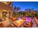 Covered patio with a cozy fire table, providing a perfect space for outdoor relaxation and evening entertainment at 2994 San Lorenzo Ct, Henderson, NV 89052