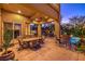 Beautiful patio area with bar stools, outdoor dining, grill, and pool with lush landscaping at 2994 San Lorenzo Ct, Henderson, NV 89052