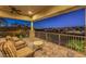 This covered patio offers a golf course view and comfortable seating. The city lights are visible in the distance at 2994 San Lorenzo Ct, Henderson, NV 89052