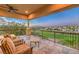 Covered patio featuring golf course view with comfortable seating and ceiling fan at 2994 San Lorenzo Ct, Henderson, NV 89052