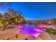 Backyard pool and spa with a waterfall feature and colorful LED lighting at dusk at 2994 San Lorenzo Ct, Henderson, NV 89052