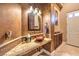 Unique powder room featuring a decorative sink, custom wall finish, and elegant lighting fixtures, adding charm to the space at 2994 San Lorenzo Ct, Henderson, NV 89052