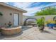 Serene backyard with a decorative fountain, mural, and desert landscaping at 3101 Margarita St, Pahrump, NV 89048