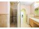 Bathroom featuring an accessible tiled shower, light cabinets, and ample counter space at 3101 Margarita St, Pahrump, NV 89048