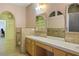 Bathroom with double sink vanity, tiled shower with glass door and archway to another room at 3101 Margarita St, Pahrump, NV 89048