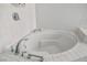 Close up of a white tiled bathtub, with a chrome faucet, and surrounding tiled deck at 3101 Margarita St, Pahrump, NV 89048