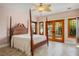 Bright bedroom with four-poster bed and french doors leading to outdoor space with lush landscaping at 3101 Margarita St, Pahrump, NV 89048