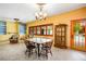 Bright dining room with a wooden table, built-in cabinets, and a glass door leading to the outside at 3101 Margarita St, Pahrump, NV 89048