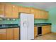 Spacious kitchen design with a refrigerator, wine cooler, and light wood cabinetry against colorful walls at 3101 Margarita St, Pahrump, NV 89048