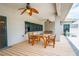 Covered patio with wooden table set, decorative ceiling fans, and verdant views into the backyard at 3101 Margarita St, Pahrump, NV 89048