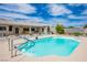 Backyard pool surrounded by patio and lush greenery, complete with a charming covered outdoor lounge area at 3101 Margarita St, Pahrump, NV 89048