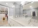 Contemporary bathroom featuring dual sinks, marble countertops, and direct access to a spacious walk-in closet at 3111 Bel Air Dr # 3C, Las Vegas, NV 89109