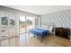 Modern bedroom with balcony access, city views, and a unique accent wall with geometric patterns at 3111 Bel Air Dr # 3C, Las Vegas, NV 89109