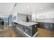 Contemporary kitchen with a large island, bar seating, and view into the living area at 3111 Bel Air Dr # 3C, Las Vegas, NV 89109