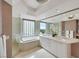 This primary bathroom features a double sink, standalone shower, and garden tub with large window views at 322 Karen Ave # 708, Las Vegas, NV 89109