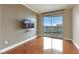 Bedroom featuring hardwood floors, a mounted television, and a balcony with city view at 322 Karen Ave # 708, Las Vegas, NV 89109