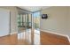 Bedroom with hardwood floors, balcony access, and a mounted television at 322 Karen Ave # 708, Las Vegas, NV 89109